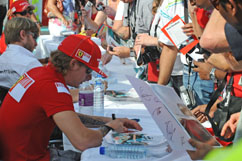 Kimi signs autographs