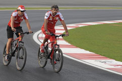 Fernando inspects race track with bicycle